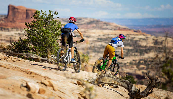 2 mountain bikers riding around Moab Utah.